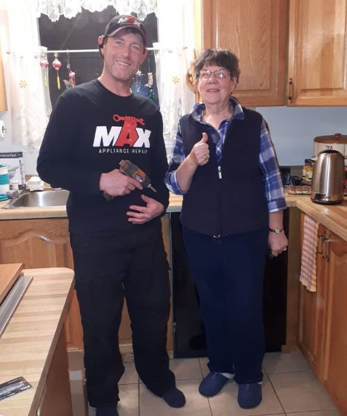 kitchen appliance repair in caledon, happy customer posing with technician