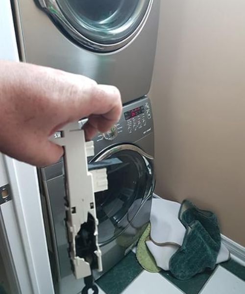 washer and dryer repair being performed