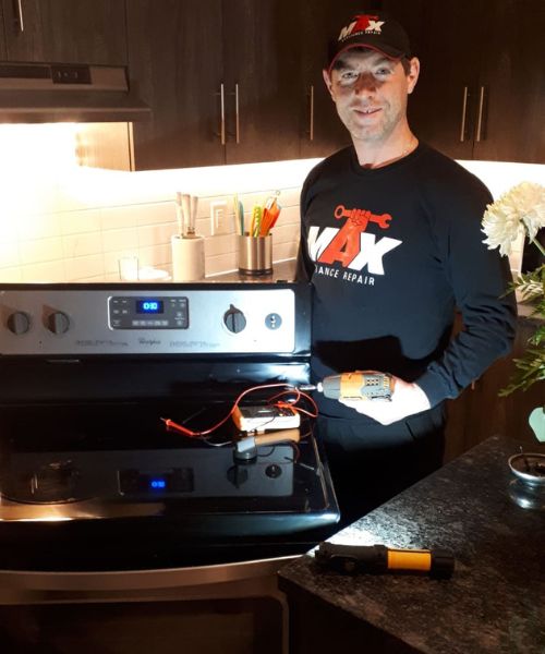 Technician stands with tools after fixing stove