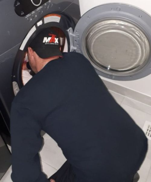 technician repairing washer in alliston