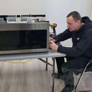 technician repairing samsung over the range microwave